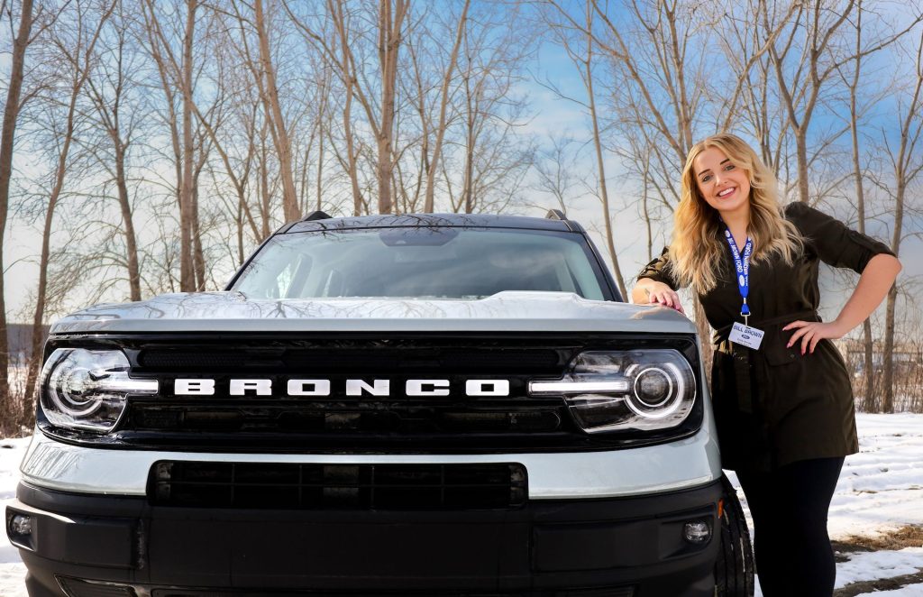 Emily, a Service Advisor at Bill Brown Ford outside of her new Bronco Sport