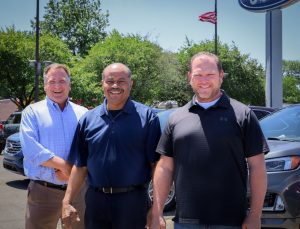 Bill Brown Ford in Livonia, MI, Sales Associates Thom Howard, Levell Baldridge, or Chris Baxter standing in front of new 2022 Edges.